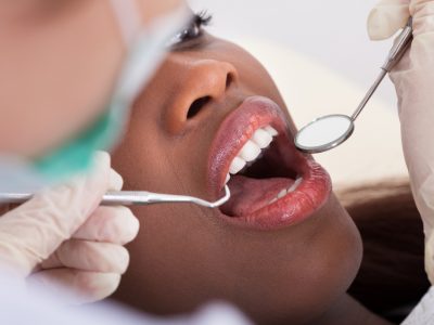 Patient Being Examined By Dentist